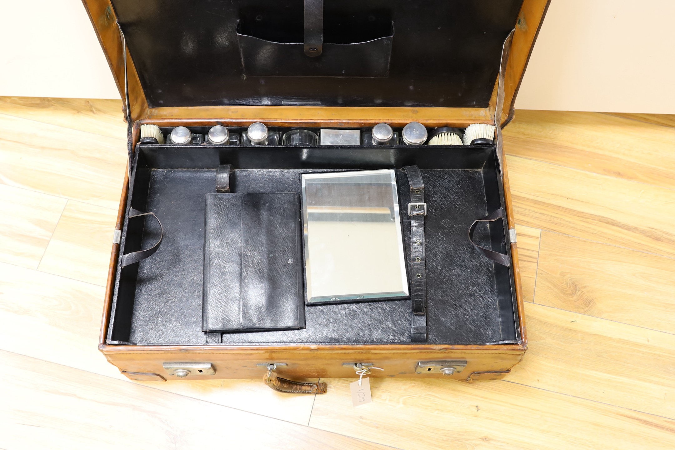 A Dupont travel suitcase, initialled ‘L.C.’ with French white metal mounted bottles